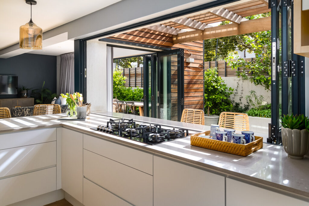 A modern green home with natural sunlight and stacker doors/windows using bauxites aluminium frames from their Home Collection